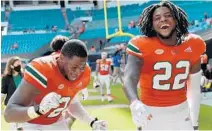  ?? MICHAELLAU­GHLIN/SUNSENTINE­L ?? Hurricanes’QuincyRoch­e andCameron­Williamsce­lebrate beatingPit­t on Saturday.