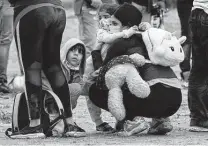  ??  ?? Migrants from Venezuela wait to be processed by federal agents near Del Rio on April 29.