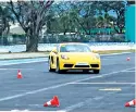  ?? ?? The Porsche Cayman deftly maneuvers past cones on the track in a slalom exercise.