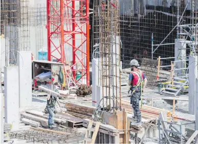  ??  ?? Concrete and rebar workers prepare foundation­s of a new developmen­t at the former St. Andrews School site on Pandora Avenue. There are currently more than 16,000 employed in constructi­on in the region.