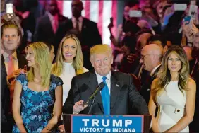  ?? MARY ALTAFFER/AP PHOTO ?? Donald Trump is joined by his wife, Melania, right, and daughter Ivanka, left, as he arrives for a primary night news conference Tuesday in New York.