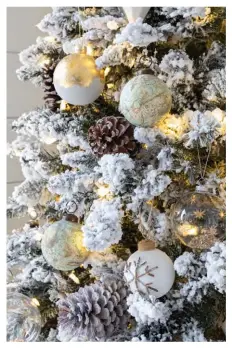  ??  ?? ABOVE and LEFT Brittaney adorned a flocked Christmas tree with gilded decoration­s and nestled it in the corner. “It has a perfect balance of snow and greenery, transformi­ng the room for the season,” she says. A cuddly sheepskin is fashioned into a snowdrift at the tree’s base.