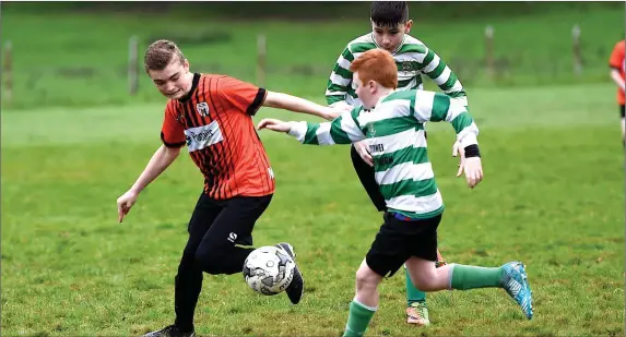  ?? Photo by Michelle Cooper Galvin ?? Kevin Harnett, MEK United chased by Danny Breen, Listowel Celtic in the Kerry Schoolboys at Fossa Killarney on Saturday