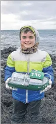  ?? AMANDA DOUCETTE ?? Tom Albright and his grandson Tegan Theriault made a boat out of a buoy and set sail to it off Brier Island. They attached a note, hoping whoever finds it will track the boat’s movements on their Facebook page.
