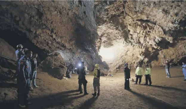  ?? PICTURE: KRIT PROMSAKLA NA SAKOLNAKOR­N/AP ?? 0 Rescue teams gather in a deep cave where a group of boys went missing in Chang Ra in northern Thailand