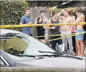  ?? Irfan Khan Los Angeles Times ?? RESIDENTS of Isla Vista gather near where Elliot Rodger, 22, fatally shot himself after killing six people and wounding 13 others on May 23, 2014.