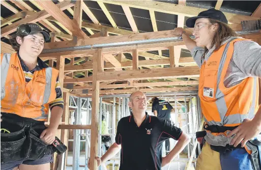  ?? PHOTO:GREGOR RICHARDSON ?? Training boost . . . Otago Polytechni­c ITAB coordinato­r Matt Thompson is flanked by Regan Jefferson (16, left) and Liam Madigan (19). The pair are two of 16 pretrade students building houses to be sold or auctioned for charity in Dunedin.