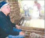  ?? FILE PHOTO ?? Leonard Reed, a descendant of one of Cane Hill’s earliest families, attended the 2011 Cane Hill Harvest Festival and watched over a large copper vat of sorghum cane juice which was cooked over hot coals until it was ready as sorghum molasses.