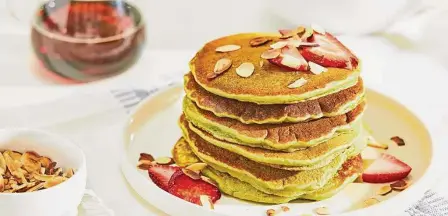  ?? Tom McCorkle/for the Washington Post ?? For a verdant tint and boost in nutrition, add matcha tea to the unsweetene­d pancake batter, then top with almonds.