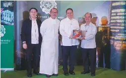  ??  ?? Fr. Jett Villarin, S.J. (second from right), president of the Ateneo de Manila University (ADMU), receives the first copy of SiyaNga!Reflection­swithArt from Br. Raymundo Suplido, FSC (right), president of De La Salle University (DLSU) during the book’s launch at the DLSU’s Henry Sy Sr. Hall on January 28. With them are Dr. David Jonathan Bayot (far left), executive publisher of the DLSU Publishing House, and DLSU Chancellor Br. Bernie Oca, FSC.