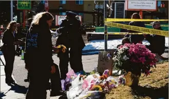  ?? Geneva Heffernan / Associated Press ?? People grieve near a gay nightclub in Colorado Springs, Colo., on Sunday after a shooting occurred late Saturday night.