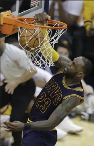  ?? DARRON CUMMINGS — ASSOCIATED PRESS ?? LeBron James throws down two of his 41 points during the Cavaliers’ monstrous second-half comeback April 20 in Indianapol­is.