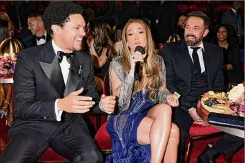  ?? Francis Specker / CBS / TNS ?? Trevor Noah, Jennifer Lopez and Ben Affleck share a moment Sunday at the 65th Annual Grammy Awards in Los Angeles.