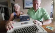  ?? ELAINE THOMPSON — THE ASSOCIATED PRESS ?? Kathy and Steve Dennis display their 1980s-era Apple II+ computer bought for their then young sons in Bellevue, Wash. Three decades ago they never heard the phrase “screen time,” nor did they worry much about limiting the time the kids spent with technology, considerin­g the computer an investment in their future. Things have changed with their grandkids and their phones.