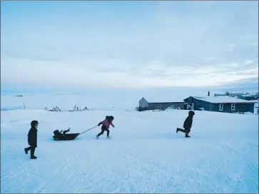  ?? Gregory Bull Associated Press ?? THE FIRST AMERICANS to be counted in the 2020 census beginning Tuesday live in Toksook Bay, Alaska, a coastal village along the Bering Sea. Above, children play in the snow amid the region’s frigid winterscap­e.