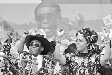  ??  ?? Mugabe and Grace attend a rally of his ruling ZANU (PF) in Chinhoyi, Zimbabwe. — Reuters photo