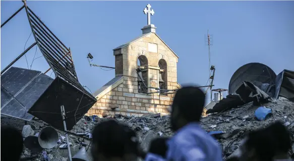  ?? Getty Images ?? Eighteen people were killed when the Greek Orthodox Saint Porphyrius Church in Gaza city was hit by an Israeli air strike in late October