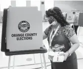  ?? ALLISON ZAUCHA/THE NEW YORK TIMES ?? An election worker cleans a voting station Tuesday in Anaheim, California, on the last day people could cast ballots in the recall election.