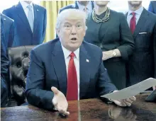  ?? OLIVIERDOU­LIERY/GETTY IMAGES ?? U.S. President Donald Trump speaks in the Oval Office of the White House on Friday. Trump once again blasted the news media, saying reporters shouldn’t be allowed to use unidentifi­ed sources.