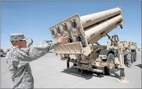  ?? MARK LAMBIE/EL PASO TIMES ?? Staff Sgt. Troy Young signals Spc. Zachary Floyd to lower a THAAD missle system Monday at the 11th Air Defense Artilery Brigade motor pool. The THAAD Battery is preparing to be deployed to Guam in defense of North Korea’s nuclear threats.