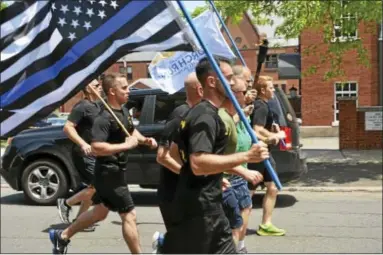  ?? CASSANDRA DAY — THE MIDDLETOWN PRESS ?? The annual Special Olympics Connecticu­t Law Enforcemen­t Torch Run arrived in Middletown Thursday afternoon, during the North Branford-to-Hartford leg.