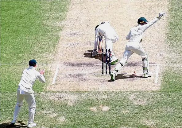  ?? Reuters ?? The end: England’s Moeen Ali (centre) is stumped by Australia’s wicketkeep­er Tim Paine during the fourth day of the first Ashes in Brisbane on Sunday. —