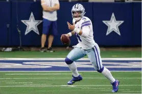  ?? The Associated Press ?? Dallas Cowboys quarterbac­k Dak Prescott (4) scrambles out of the pocket before throwing a pass in the second half of an Oct. 4, 2020, game against the Cleveland Browns in Arlington, Texas. It’s too early to know where the NFL salary cap will end up in the range of $180 million to $198 million coming off a pandemic-dominated season that was completed on time but still cost the league billions of dollars in revenue. It’s a potential problem for the Cowboys if they can’t get a long-term deal with quarterbac­k Dak Prescott, which would cause his cap charge to hit $37 million with another franchise tag after being around $31 million last year.