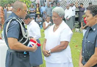  ?? Photo: Waisea Nasokia ?? Fiji Police Commission­er Brigadier-General Sitiveni Qiliho hands over the flag to Lusiana Tagicakiba­u Bokadi at Namatakula Village, Nadroga, on February 9, 2018.