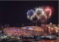  ?? Li Xin / AFP / TNS ?? Fireworks in the shape of the Olympic rings go off over the National Stadium, known as the Bird’s Nest, in Beijing, during the opening ceremony of the 2022 Winter Olympic Games on Friday.