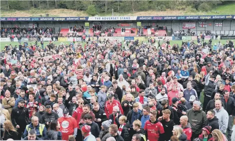  ?? ?? PROMOTION PARTY: The Boro fans flock onto the Flamingo Land pitch for the post-match presentati­ons