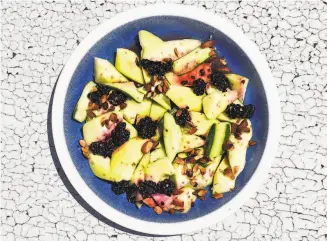  ?? Christian Reynoso ?? A tangy salad of marinated melon and blackberri­es screams summer with every juicy bite.