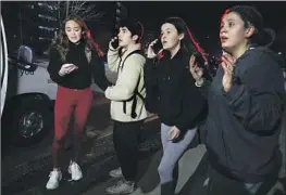  ?? Bill Pugliano Getty Images ?? MICHIGAN STATE UNIVERSITY students react Monday to news of an active shooter on campus. Three students were killed, and five remain hospitaliz­ed.