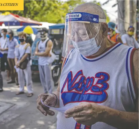  ?? EZRA ACAYAN / GETTY IMAGES ?? People line up for free COVID-19 testing outside a hospital in Manila, Philippine­s, on Monday. President Rodrigo Duterte is reimposing a strict lockdown in Manila and surroundin­g provinces for two weeks starting Tuesday, as the country continues to struggle with rising coronaviru­s infections.