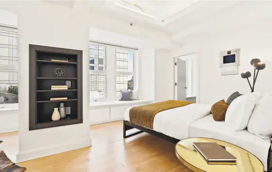  ?? AERIAL CANVAS ?? Above: This bedroom enjoys window seats, builtin shelving and an en suite bathroom. Below: A jetted tub highlights this spa bathroom that includes a contempora­ry floating vanity.