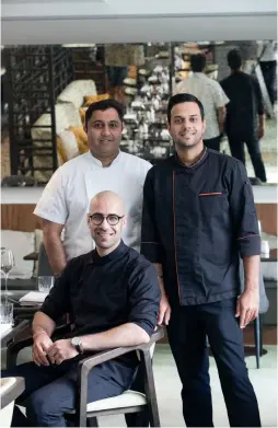  ??  ?? ABOVE LEFT TO RIGHT Vaibhav Vishen of Spring Kitchen (seated) with Ashish Dhar (left) and Rajesh Barwal (right); tomato charcoal chicken by Spring Kitchen.