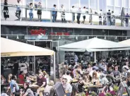  ??  ?? People sit at an outdoor restaurant on the South Bank during sunny weather in London, U.K., June 5, 2021.