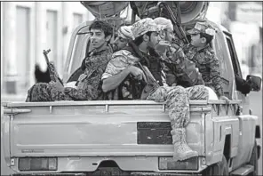  ?? AP/HANI MOHAMMED ?? Houthi Shiite fighters
wearing army uniforms patrol the streets Friday in Sanaa, Yemen.