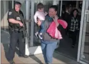  ?? RICK BOWMER—ASSOCIATED PRESS ?? Shoppers with their hands raised are evacuated from Fashion Place Mall in Murray, Utah, after a shooting on Sunday, Jan. 13, 2019.