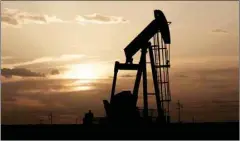  ??  ?? Oil pump jacks work at sunset near Midland, Texas.
REUTERS