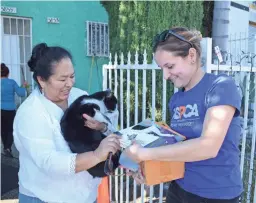  ?? ASPCA VIA AP PHOTOS ?? ASPCA L.A. Community Engagement Manager Denise Bohn, right, delivers supplies to a client, a cat named Oreo and her owner, Josefina Tejada, in Los Angeles. Animal welfare experts say there are many sad but good reasons why people have to relinquish pets. Today’s shelters try to offer advice, material aid and other kinds of help to keep pets and owners together. But they also can help determine when it’s time to find a pet a new home.