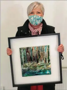  ??  ?? Helen Woods with her painting ‘Into the Woods’.