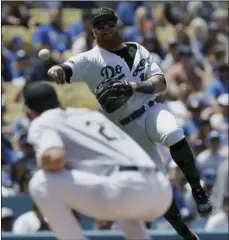  ?? PHOTO/ALEX GALLARDO ?? Los Angeles Dodgers third baseman Justin Turner (right) throws over starting pitcher Walker Buehler, but not in time to get out San Diego Padres’ Jose Pirela on an infield single during the fourth inning of a baseball game in Los Angeles, on Sunday. AP