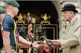  ??  ?? 69 YEARS APART: At a 1948 boxing event, top, and with Marines in 2017