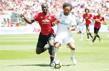  ?? - AFP photo ?? Marcelo Da Silva Junior #12 of Real Madrid and Eric Bailly #3 of Manchester United go for the ball during the Internatio­nal Champions Cup match at Levi’s Stadium on July 23, 2017 in Santa Clara, California.