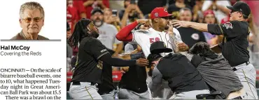  ?? SAM GREENE / ASSOCIATED PRESS ?? Cincinnati Reds pitcher Amir Garrett (center) looks to throw a punch as he is held back by a number of Pirates players during a brawl on Tuesday.
