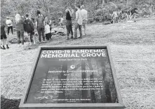  ?? Julie Carr Smyth / Associated Press ?? Various groups affected by the pandemic gather to plant trees on April 30 at Ohio’s dedication of a new COVID-19 Pandemic Memorial Grove at Great Seal State Park near Chillicoth­e, Ohio.