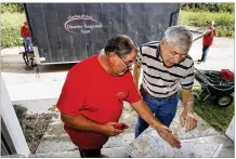  ?? CHRIS STEWART / STAFF ?? Mark Cremeans, (left) co-director of the Churches of Christ Disaster Response Team, and volunteer Jim Mong, of Columbiana, route a path to Portland, Texas.