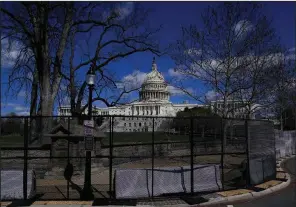  ?? (AP/Carolyn Kaster) ?? The U.S. Capitol is seen behind security fencing Friday after a car crashed into a Capitol Hill barrier in Washington, D.C.