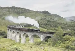  ??  ?? The Jacobite steam train crosses the Glenfinnan viaduct