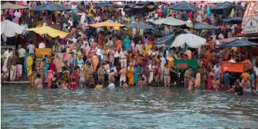  ?? IMAGES: Shuttersto­ck ?? ABOVE: Hindu worshipers bathe in the Ganges at dawn during the Kumbh Mela Festival